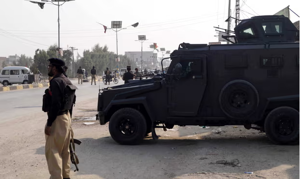 Police officers stand guard during a protest by Shia Muslims against an attack on passenger vehicles in Kurram earlier in the week. Photograph: Saood Rehman/EPA