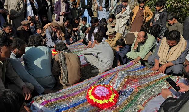 Mourners pray at the burial of the victims of Thursday’s attack. Photograph: Basit Gilani/EPA