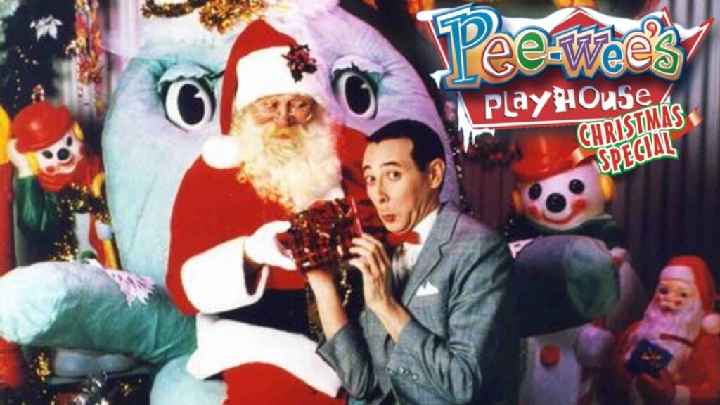 Promotional image for "Pee-wee's Playhouse Christmas Special" featuring Pee-wee Herman and Santa Claus with holiday decorations and characters in the background.