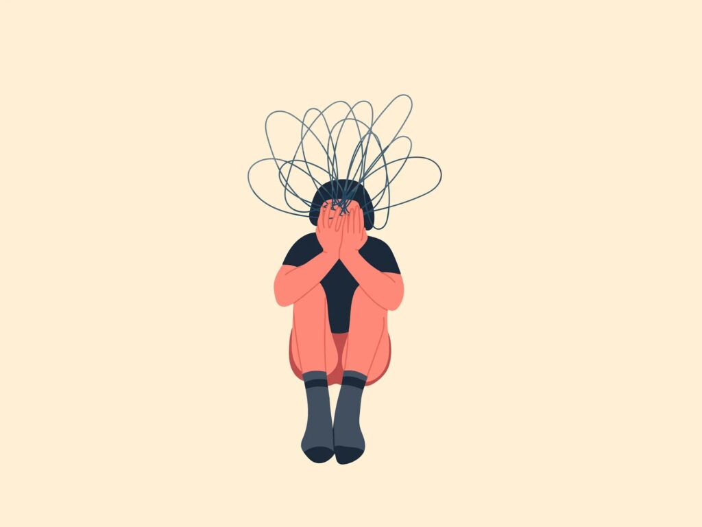 Habits to Avoid That Drain Your Energy Everyday 2 A person sitting with their head down, covering their face, surrounded by tangled lines representing mental distress.