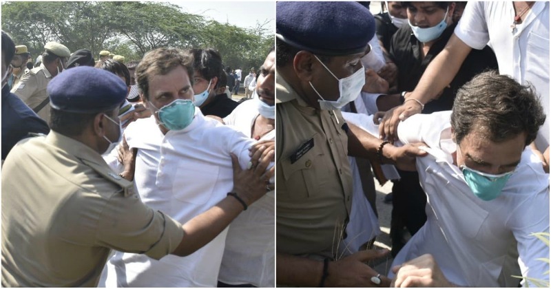 A politician is being restrained by police officers during a public event, with bystanders observing the altercation.